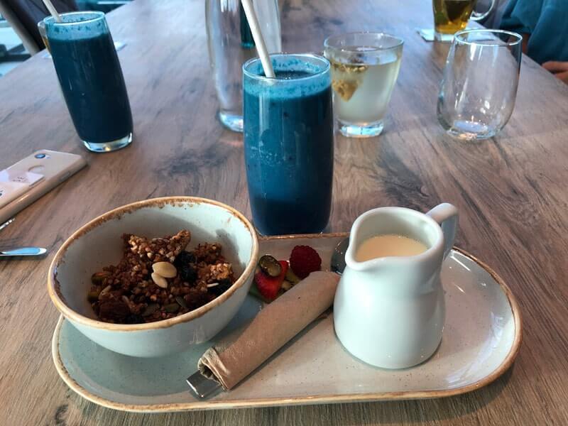 Breakfast home-made granola and a bright blue smoothie
