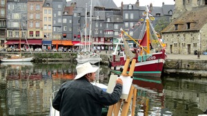 An artist paints at the Vieux Bassin