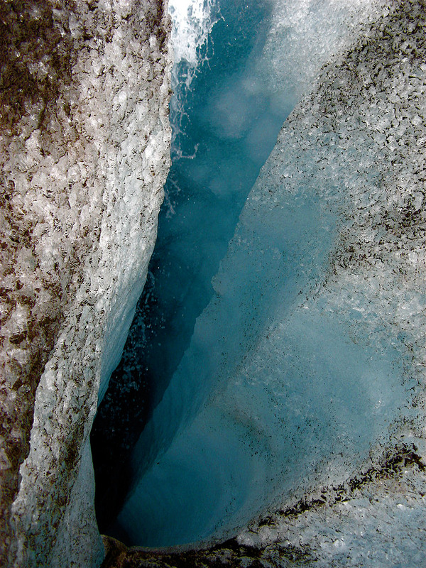 Vertical well-like shaft within Langjokull glacier - image by Ville Miettinen via Wikimedia Commons