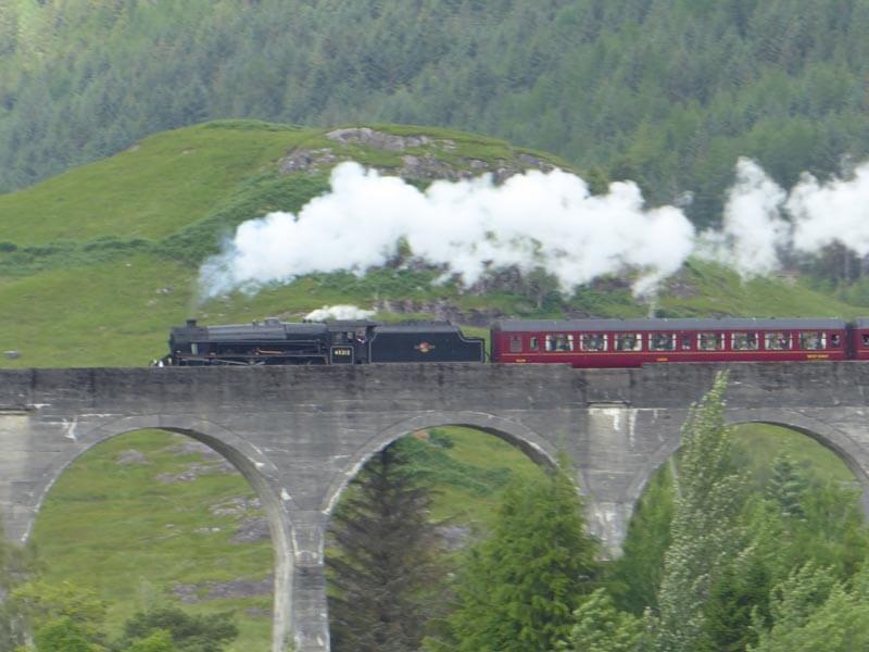 Jacobite steam train crossing Glenfinnan viaduct