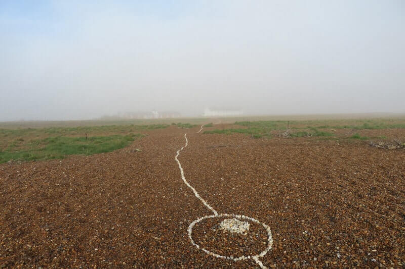The line of shells fades into the mist