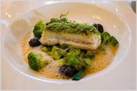 Black scabbard fish filet with herb crust, jardinière vegetables and gnocchi with cuttlefish ink