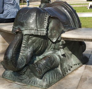 Stone circular bench which incorporates three kneeling elephants