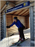 A tourist tries out the starting gate on the Men's Downhill run