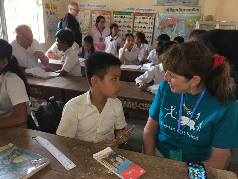 Jeannine chats to a pupil at a village school