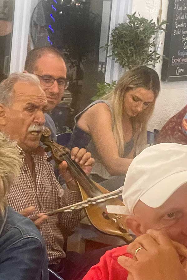 Celebrated local musician Zografidis plays his traditional lyre for diners in the Orea restaurant 