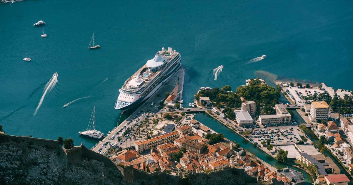 Cruise ship at the pier of the old town of Kotor. View from Mount Lovcen | Types of Cruise Holidays