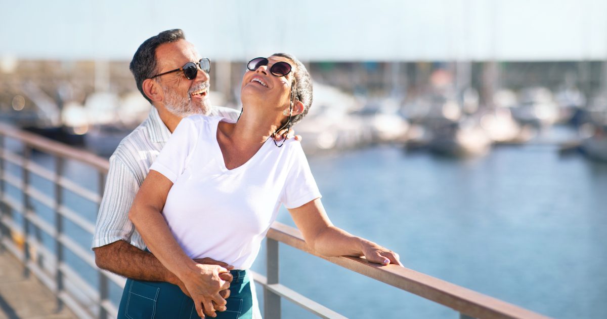 Romantic Senior Couple Embracing Expressing Happiness Standing At Marina Outside | Cruise Holidays for Singles
