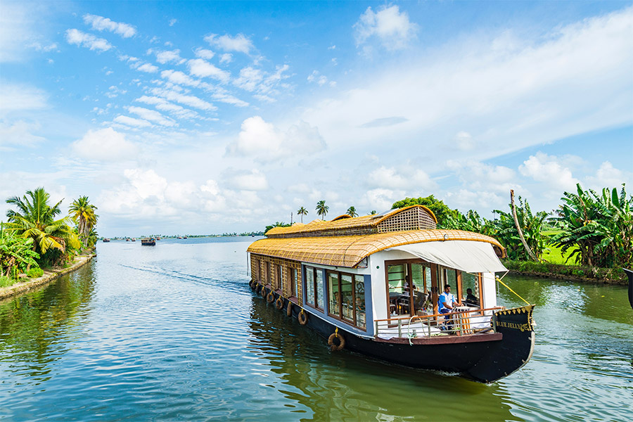 Traditional houseboat cruising through the backwaters