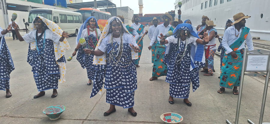 Dancers greeting passengers as they leave the ship