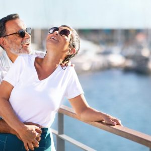 Romantic Senior Couple Embracing Expressing Happiness Standing At Marina Outside | Cruise Holidays for Singles