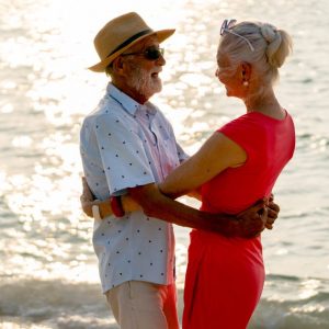 Senior man and woman hug and look to each other | Romantic Getaways for Couples in their 50s